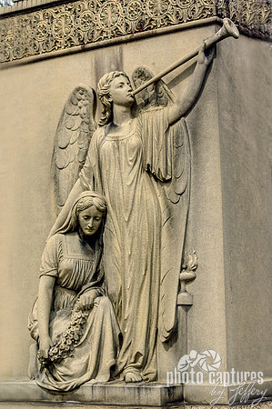 Sad female with winged angel sculpture