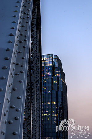 Metal Of Bridge Pinnacle Building In Background