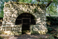 Historic stone arch and barred entrance Spring House artistic rendering