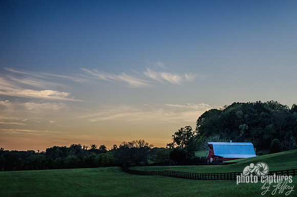 Late evening sky over red barn in green field 8x12