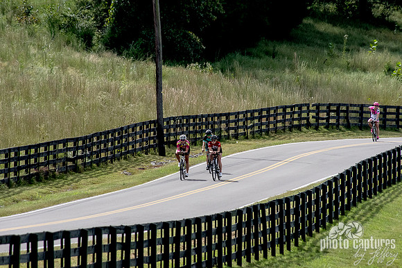 Bicyclists biking down back country road