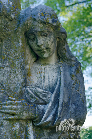Female sculpture hand on cross Elmwood Cemetery