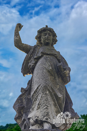 Female sculpture arm up Elmwood Cemetery