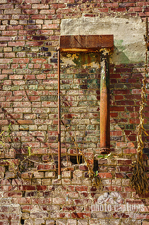 Extrerior rusty metal pipe brick wall