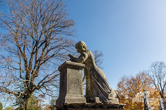 Kneeling female sculpture in prayer
