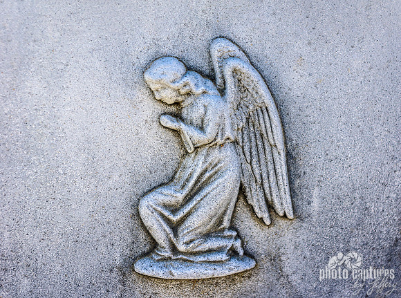 Kneeling winged angel emblem