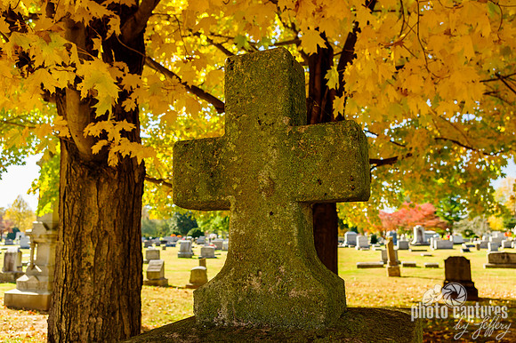 Stone cross fall colorful leaves