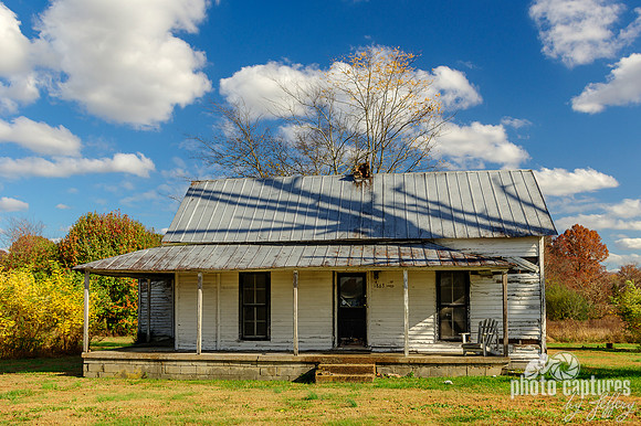 Abandoned house with nice blue white puffy sky