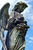 Winged Female Angel Sculpture Holding Flowers