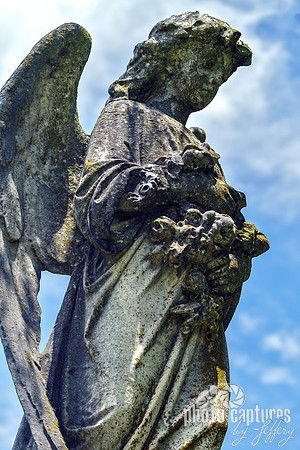 Winged Female Angel Sculpture Holding Flowers