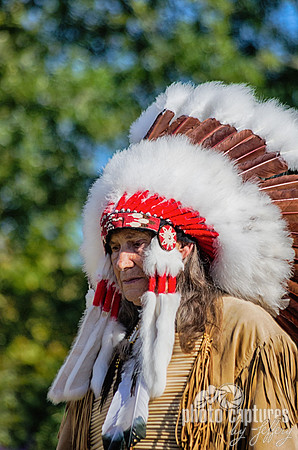 Elder dancer in buckskin full headdress NAIA Powwow