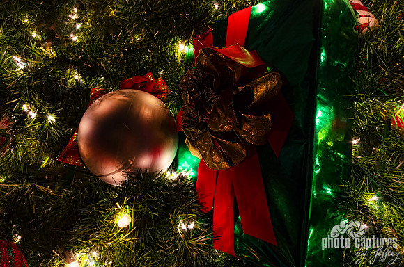 Green wrapped present hanging on Christmas Tree