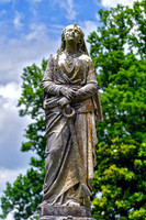 Female Sculpture Hands Resting on Anchor Front View