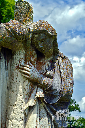 Female Sculpture Head and Hand on Cross