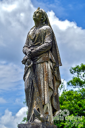 Female Sculpture Hands Resting on Anchor Side View